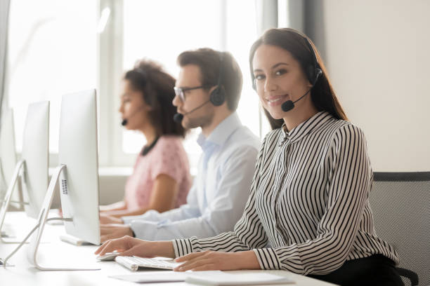 istock Call center worker female working with colleagues looking at camera 1147384851