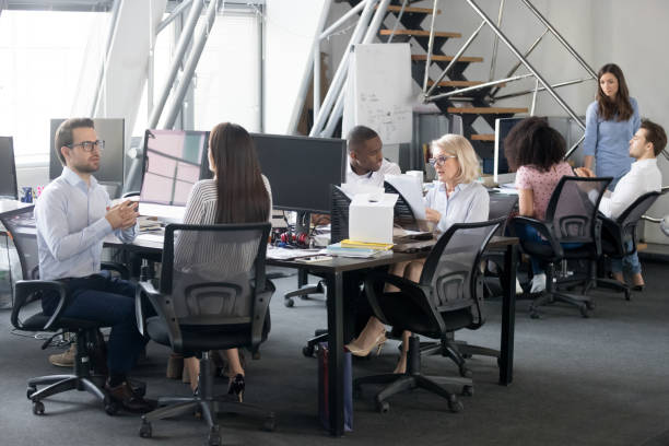 istock Busy multi racial office employees working in coworking shared room 1147384885