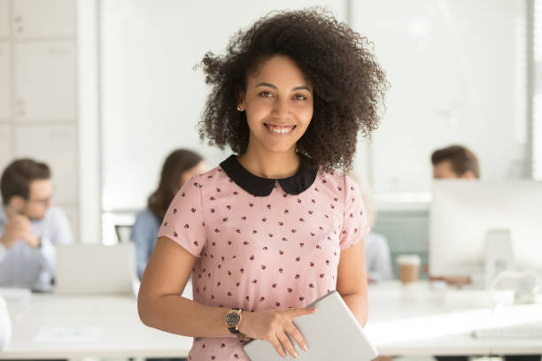 istock Confident biracial company head looking at camera pose in coworking 1147384887