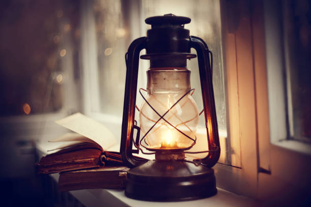istock Kerosene lamp and old books 1147386021