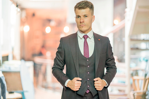 Handsome and attractive Caucasian ethnicity businessman well-dressed in elegant and luxurious formal suit.