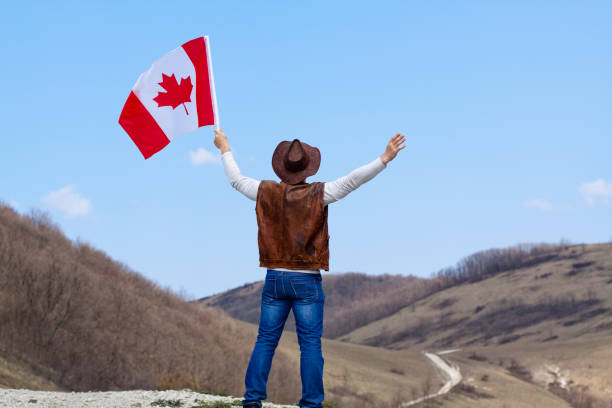 istock A man in a cowboy hat take canadian flag 1147386615