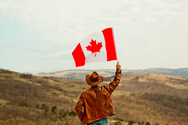 istock A man in a cowboy hat take Canadian flag 1147386887