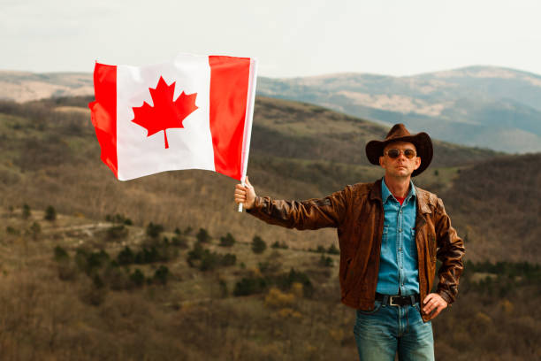 istock A man in a cowboy hat take Canadian flag 1147387179