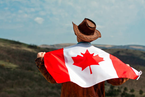 istock A man in a cowboy hat take Canadian flag 1147387272