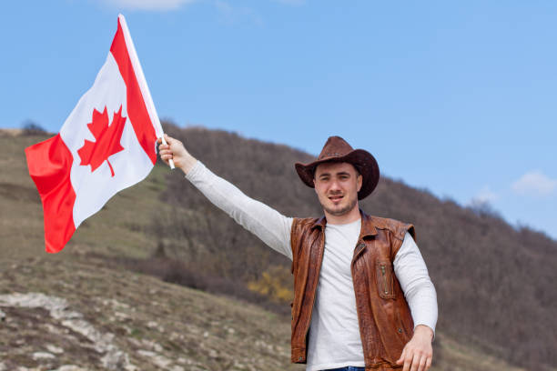 istock A man in a cowboy hat take Canadian flag 1147387538