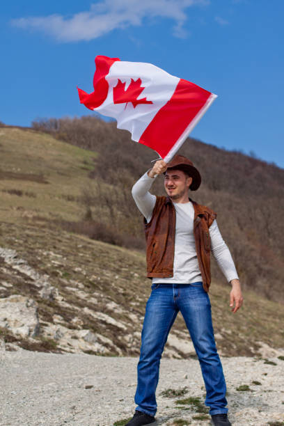 istock A man in a cowboy hat take Canadian flag 1147388504