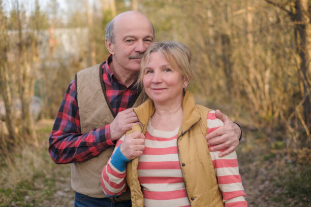 istock Senior woman and man walking in park 1147390046