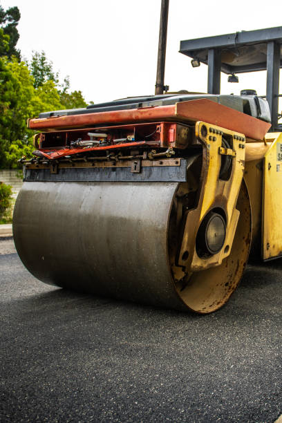 istock Large Steamroller Smoothing New Asphalt Down on Street 1147390398