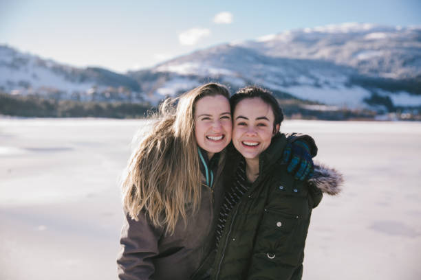 istock Two Friends Smiling and Laughing in the Snow 1147391304