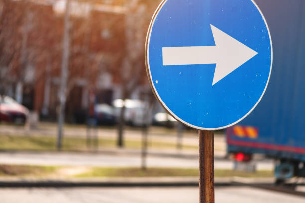 One Way sign in front of a blue sky