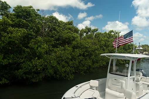 Key Largo, United States - August 16, 2018: A close-up view of a nautical vessel with the American Flag at the John Pennekamp Coral Reef State Park in the Florida Keys - USA