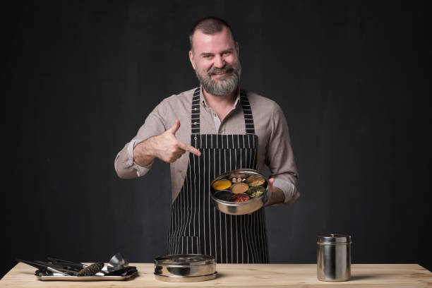 istock Bearded male chef showing different spices he uses. 1147394878