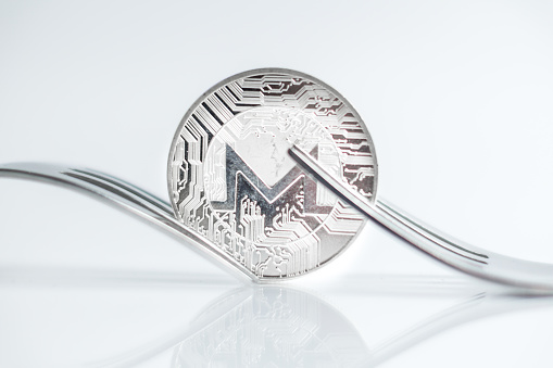 Macro photo of Monero cryptocurreny fork concept with reflection, hard fork 12.1.2019 Ljubljana Slovenia