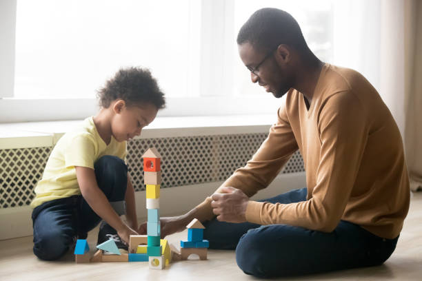 istock African American father and adorable son building constructor tower 1147395630