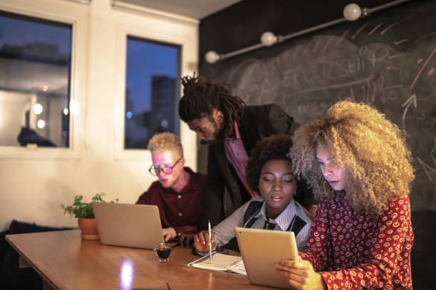 istock Group of coworkers working together at night 1147396166