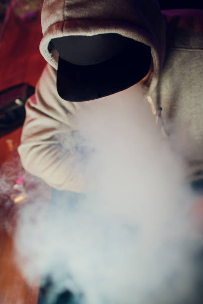 istock portrait of young man smoking an e-cigarette vape 1147396264