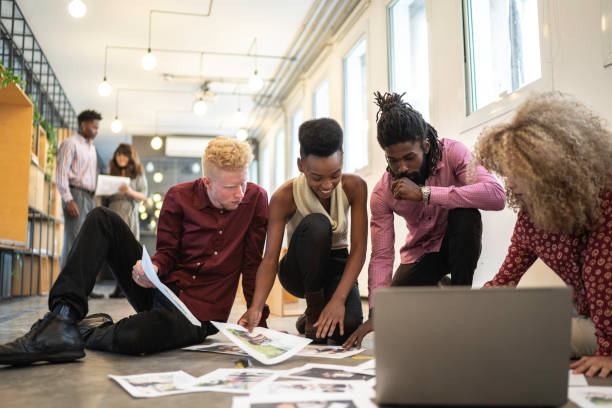 istock Business team discussing some papers on the floor in the office 1147398569