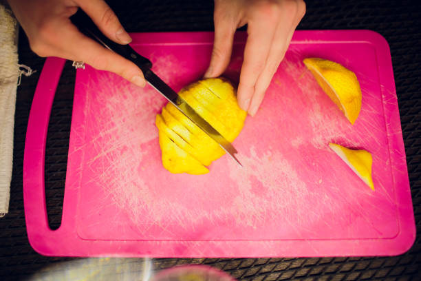istock Limes sliced on a board with a knife 1147398924