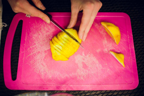 istock Limes sliced on a board with a knife 1147398950