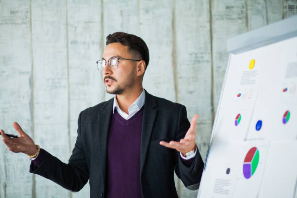 istock Young hipster businessman perform his ideas on white chalkboard 1147399291