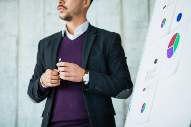 istock Young hipster businessman perform his ideas on white chalkboard 1147399835