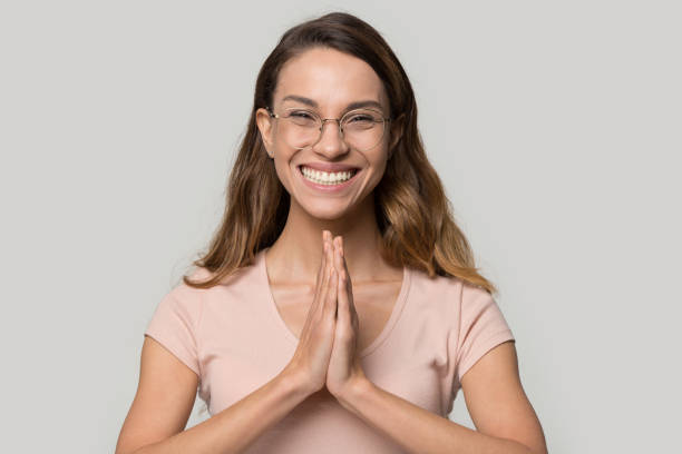 istock Attractive smiling woman in glasses make Namaste gesture 1147400525