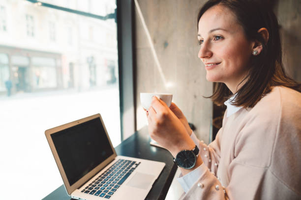 istock A businesswoman drinking tea and working in a coffeeshop 1147401736