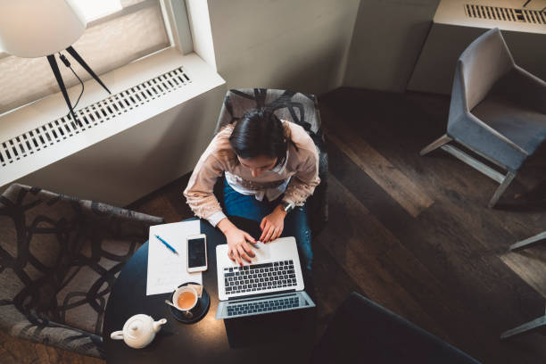 istock A businesswoman working alone in a coffeeshop 1147401881