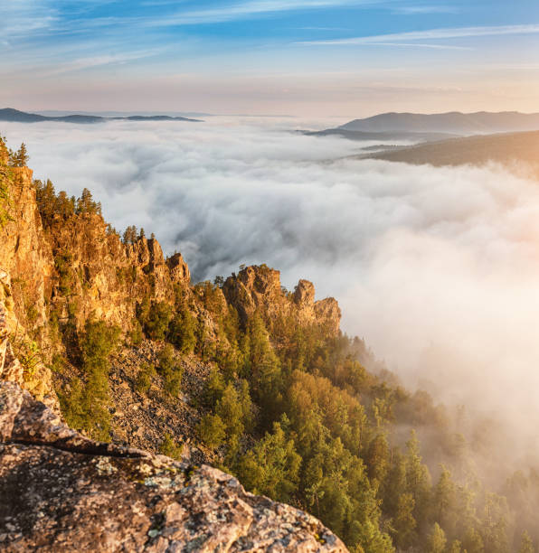 istock Rocks cliff with fog in mountains 1147403030