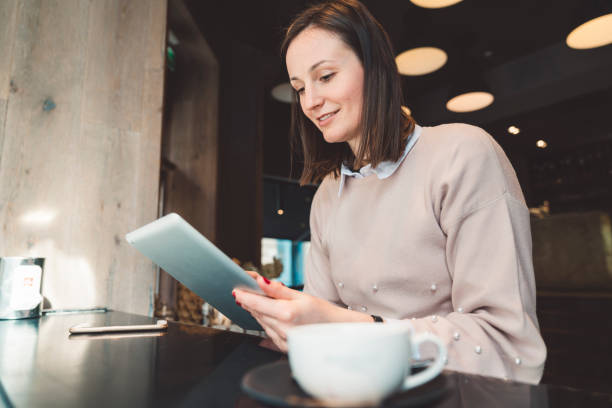 istock A woman drinking tea and doing business away from office 1147403047