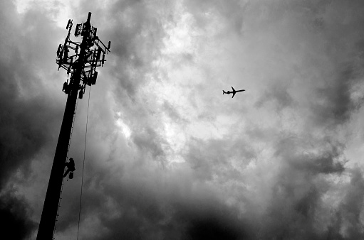 Construction of a Communications Tower as a storm approaches captured in black and white