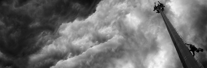 Construction of a Communications Tower as a storm approaches captured in black and white