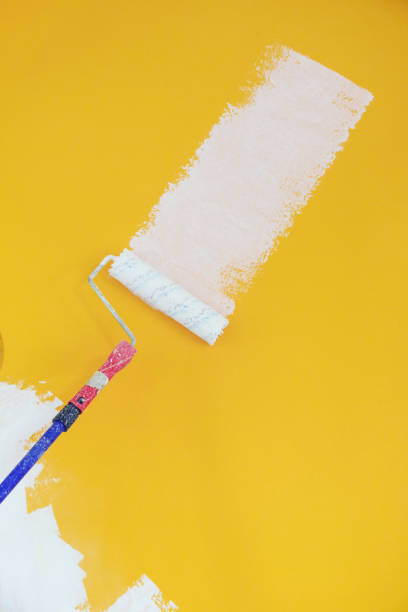 istock Painting with white paint over a yellow wall 1147404399