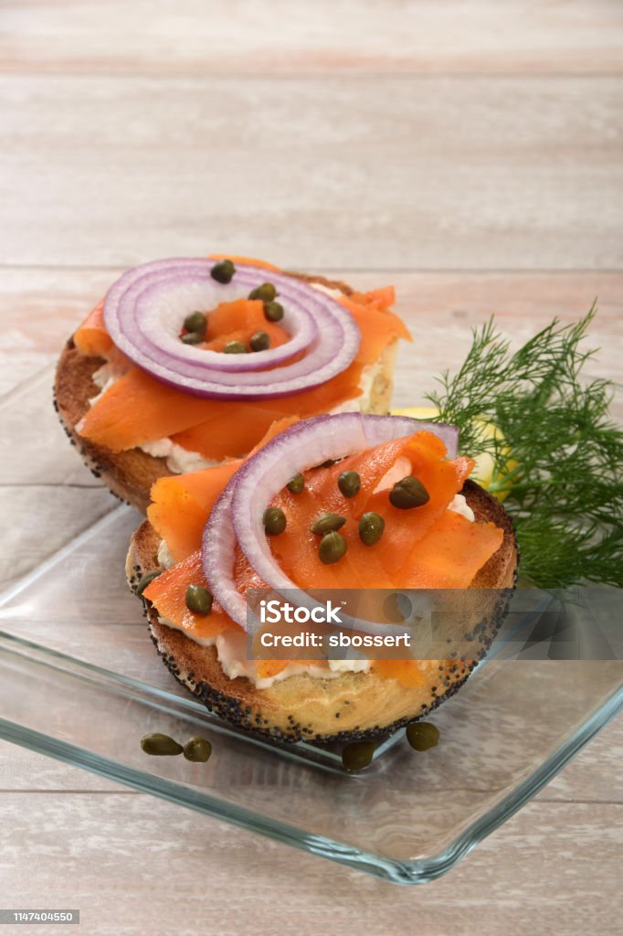 Vegan Carrot Imitation Lox with Almond Milk Cream Cheese A purely vegan take on a classic breakfast food - marinated carrot slices with the look of smoked salmon on a bagel spread with vegan almond milk cream cheese. Vegan Food Stock Photo