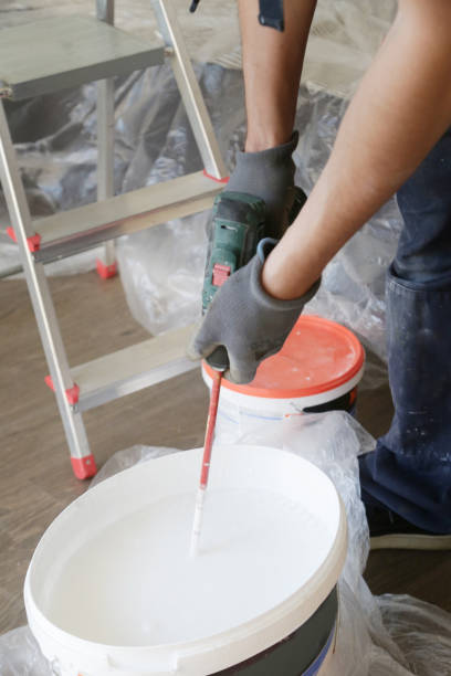 istock Man preparing white paint for interior walls 1147404573