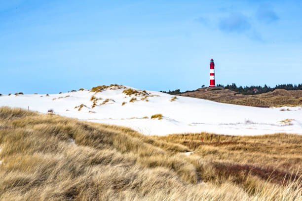 istock Red and white lighthouse on the hill 1147406719