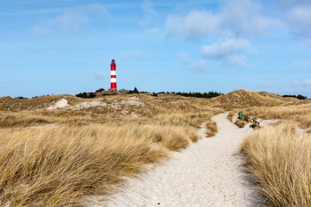istock Red and white lighthouse on the hill 1147408974