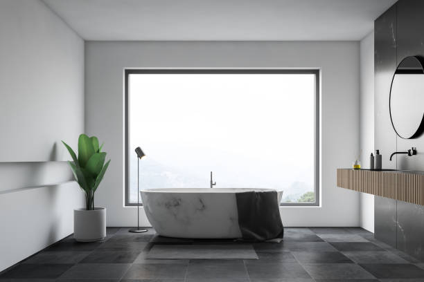 istock White bathroom with window and marble tub 1147409449