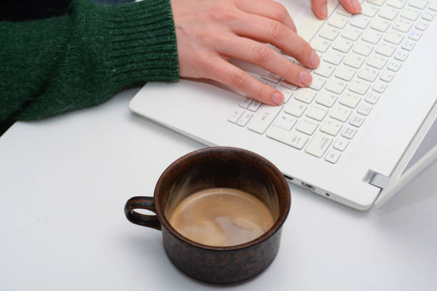 istock Woman using laptop at a white clear desk 1147412380