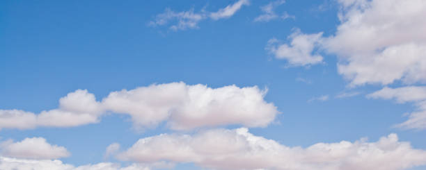 Cumulus Clouds in a Blue Sky Cumulus clouds appear in a blue sky over The Gap, Arizona, USA. jeff goulden panoramic stock pictures, royalty-free photos & images