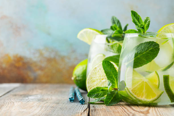 istock Two Mojito cocktail with ice cubes in a glass on a rustic table, selective focus. With copy space 1147422736