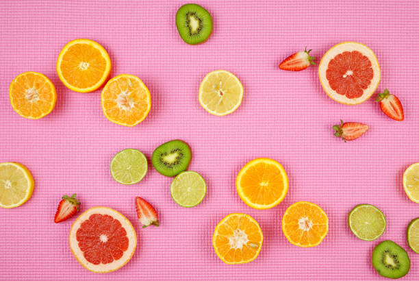 istock Summer theme background with fruit, citrus and flowers on pink backdrop. 1147424770