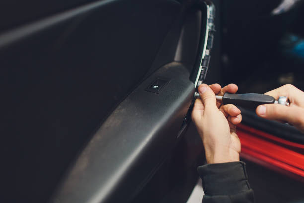 istock Mechanic installing car central door lock motor. 1147429157