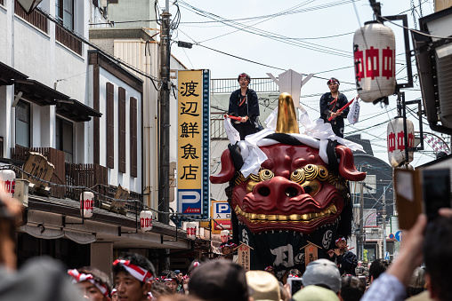 Karatsu, Japan - may 5, 2019 : people in traditional costumes drawning massive float through the street during new imperial era \