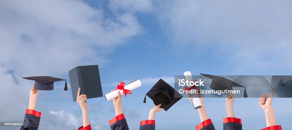 graduation ceremony hats  and hands up with sunny sky Graduation Stock Photo