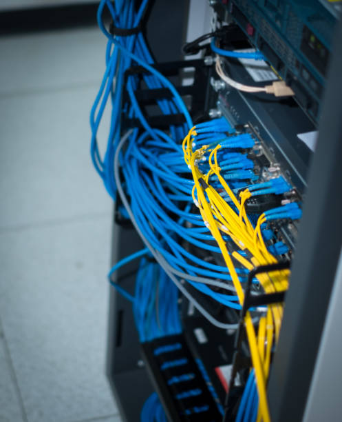 istock UTP Network cable and Fiber optic cable connected to network gigabit switch in a datacenter room. 1147436901