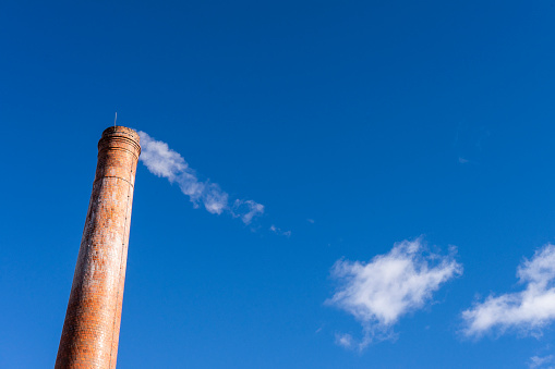 A factory Chimney on a blue sky
