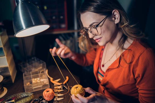 istock Young woman making jewelry 1147439509