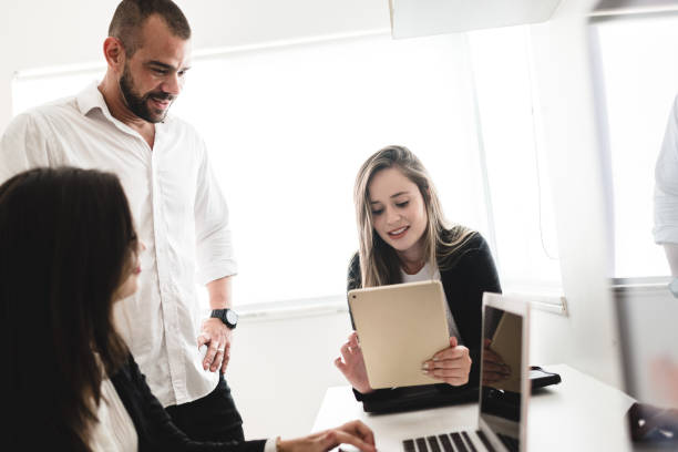 istock Businesswoman manager passing information to co-workers 1147441944